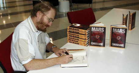 photo of Geoffrey Landis signing books